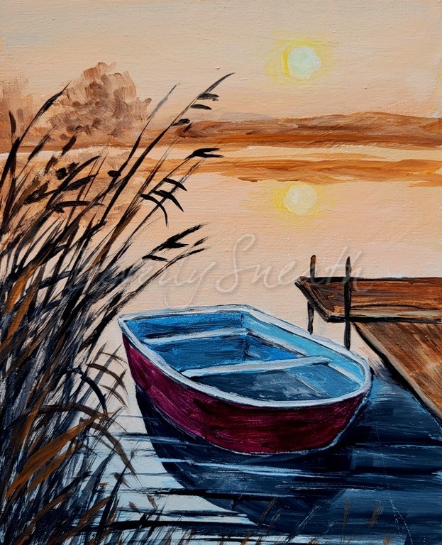 A red boat rests beside a dock on a lake at sunset with reeds in the left forground area