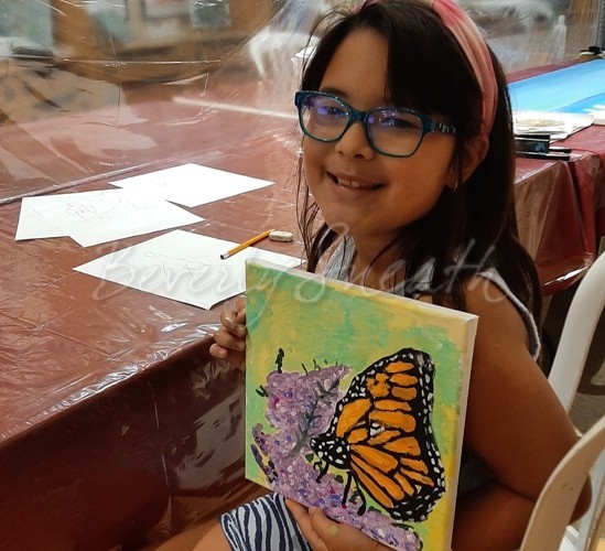 Kids Art Class, girl holding a painting of a butterfly